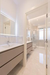 a white bathroom with a sink and a mirror at Affittacamere Sulle Stelle in La Spezia +81 photos