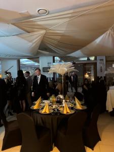 a group of people standing around a table with yellow napkins at Relax place & restaurant in Zegrze Południowe