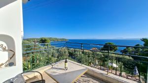 a balcony with a table and a view of the ocean at Ninareti Studios in Agia Paraskevi