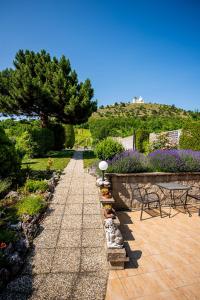 a garden with a pathway with chairs and flowers at Pod Svatým kopečkem in Mikulov
