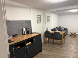a kitchen and dining room with a table and a couch at Felsenhäuschen in Monschau