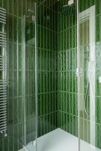 a green bathroom with a shower with a glass door at CasaCeciliamare in Ortona +37 photos