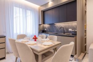 a dining room with a table and chairs and a kitchen at Affittacamere Sulle Stelle in La Spezia