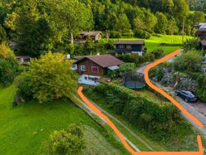 an aerial view of a house with an orange driveway at Ferienhaus mit Berg-und Seesicht in Filzbach