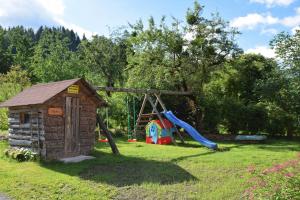 a playground with a slide and a play structure at Ferienhof Hochbrandt in Spital am Pyhrn