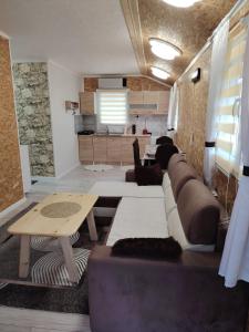 a living room with a couch and a table at Mubina Apartman in Ćukovi