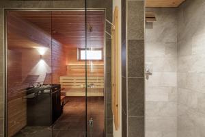 a bathroom with a glass shower and a sink at Brentsch B56 in Scuol +14 photos