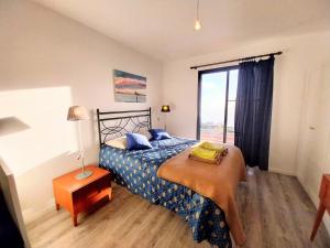 a bedroom with a bed and a large window at Madeira Native Motion Guest House in Fajã da Ovelha +80 photos