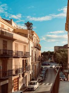 a street with cars parked on the side of a building at Dimora Beatrice in Termini Imerese