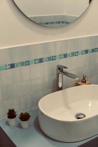 a bathroom with a white sink and a mirror at Dimora Beatrice in Termini Imerese +54 photos