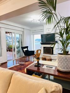 a living room with a couch and a fireplace at Eye Luxury Penthouse & apartment in Sarandë