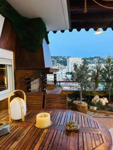 a room with a wooden table with a view of a city at Eye Luxury Penthouse & apartment in Sarandë