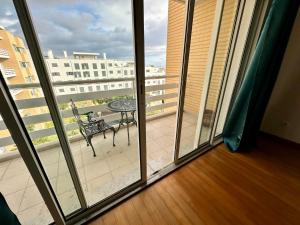 a room with a balcony with a table and a patio at Sea Soul residencial in Funchal