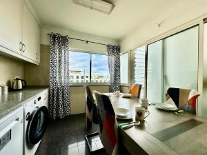 a kitchen with a table with chairs and a dining room at Sea Soul residencial in Funchal