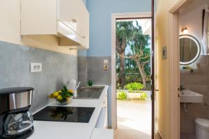a kitchen with a sink and a counter top at Hara Studios in Laganas +116 photos