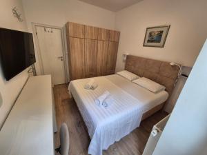a small bedroom with a bed with two towels on it at Chill apartment in Dubrovnik