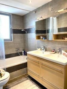 a bathroom with a sink and a tub and a toilet at Diamond Rod Villa near Faliraki in Kalithies +38 photos