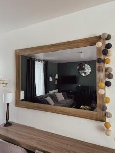 a mirror on the wall of a bedroom at Maison de Pauline, Chablis Vineyard in Préhy