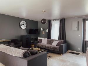 a living room with a couch and a table at Maison de Pauline, Chablis Vineyard in Préhy