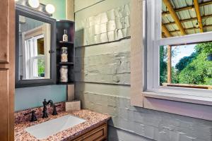 a bathroom with a sink and a window at Hillside Haven in Kodak +38 photos
