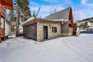 a small building with snow on the ground at Alpenglow in Brighton