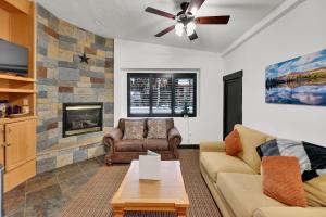 a living room with a couch and a fireplace at Alpenglow in Brighton
