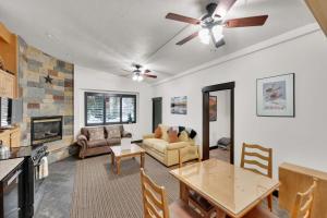 a living room with a table and a fireplace at Alpenglow in Brighton