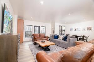 a living room with leather furniture and a table at Milly 8752 in Brighton