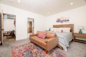 a bedroom with a bed and a couch and a chair at Milly 8752 in Brighton