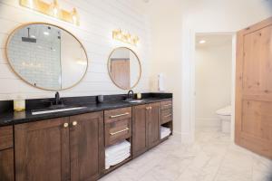 a bathroom with two sinks and two mirrors at Milly 8752 in Brighton +38 photos