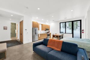 a bedroom with a blue couch in front of a bed at Milly Slopeside Studio in Brighton