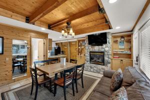 a dining room and living room with a table and a fireplace at Chalet at Brighton in Brighton