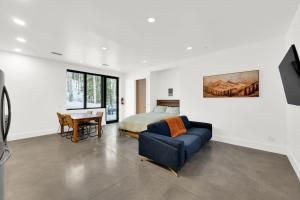 a bedroom with a bed and a couch and a table at Milly Slopeside Studio in Brighton