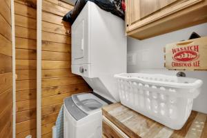 a small bathroom with a white toilet and wooden walls at Chalet at Brighton in Brighton