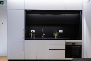 a white kitchen with a sink and a microwave at The L Smart Suite - Premium & Minimal in Ierapetra