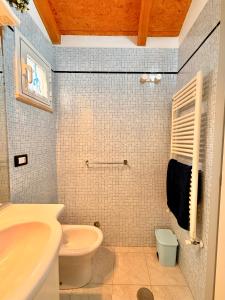 a bathroom with a sink and a toilet at Villa Chiara in Follonica
