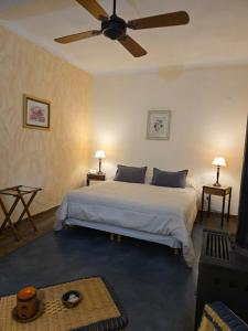 a bedroom with a large bed with a ceiling fan at Hotel Loma Bola in La Paz