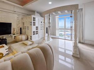a living room with a couch and a large window at Evolve Madhura in Peliyagoda
