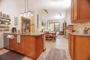 a kitchen with wooden cabinets and a dining room at Aspen Glen in Solitude