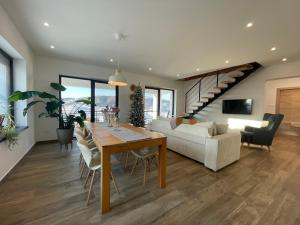 a living room with a table and a couch at Rolling Hills Holiday Haven in Odorheiu Secuiesc