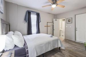a bedroom with a bed and a ceiling fan at Cozy Room in the City of Worcester in Worcester
