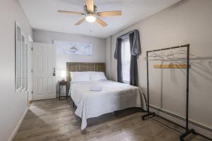 a bedroom with a bed and a ceiling fan at Cozy Room in the City of Worcester in Worcester
