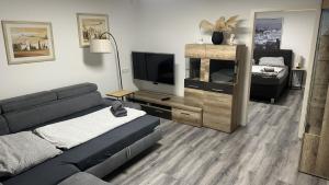 a living room with a couch and a flat screen tv at KüstenNest gepflegte großzügige Ferienwohnung Nähe Ostsee mit Garten in Ratekau