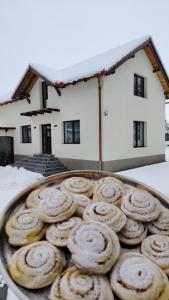 a tray of donuts in front of a house at Casa AIDA in Peşteana