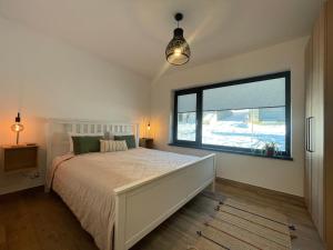 a bedroom with a bed and a large window at Rolling Hills Holiday Haven in Odorheiu Secuiesc