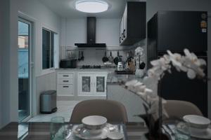 a kitchen with a glass table with chairs and a tableablish at GORGEOUS NEW DESIGNED 4br KataBeach sweetHome in Kata Beach