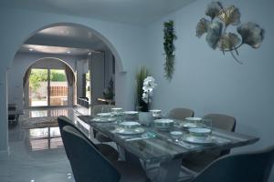 a dining room table with plates and bowls on it at GORGEOUS NEW DESIGNED 4br KataBeach sweetHome in Kata Beach