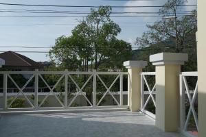a white fence with pillars on a patio at GORGEOUS NEW DESIGNED 4br KataBeach sweetHome in Kata Beach +24 photos