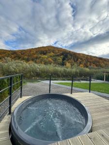 a jacuzzi tub on a wooden deck at Rika chalet in Stantsiya Dembina +11 photos