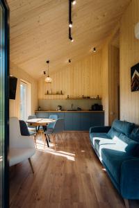 a living room with a couch and a table at Rika chalet in Stantsiya Dembina
